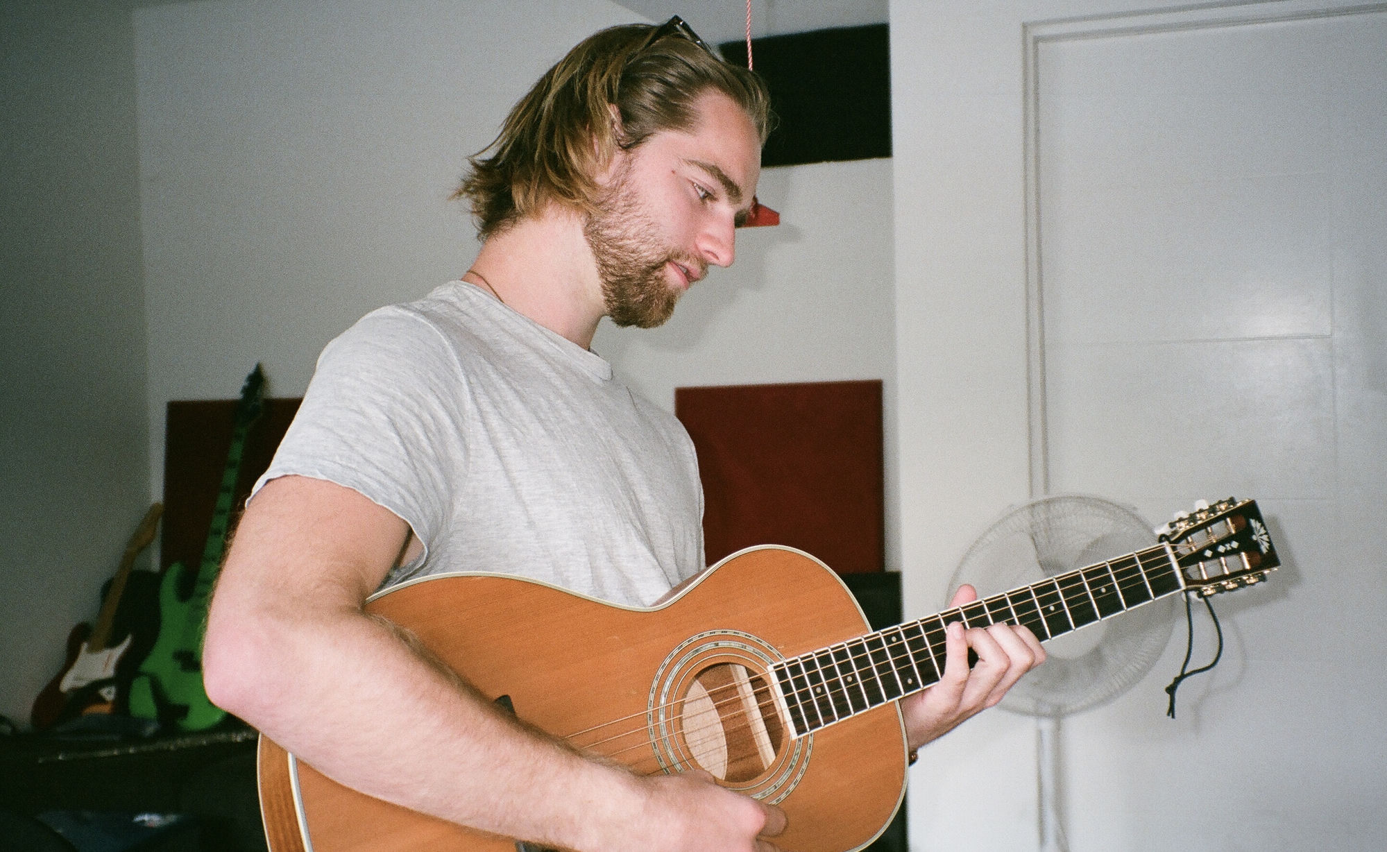 Henry Gritton playing acoustic guitar